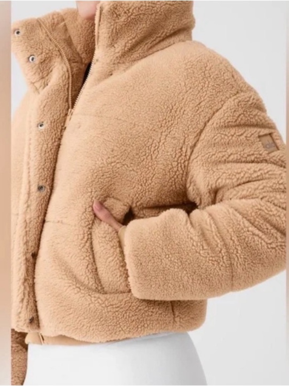Alo Yoga Sherpa Snow Angel Puffer Jacket in a plush tan color